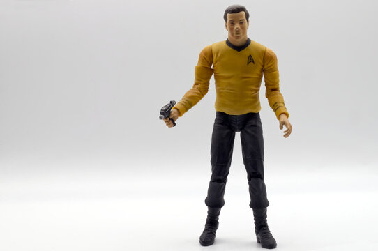 Bologna, Italy - May 22, 2026: Captain James T. Kirk action figure, wearing the yellow starfleet uniform and holding a phaser against a white background.