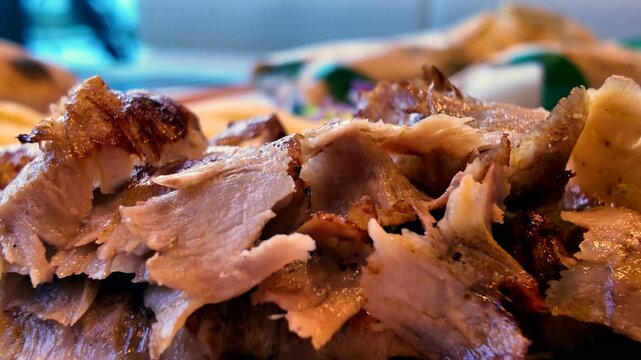 Savory, thinly sliced gyro meat sits piled high, freshly shaved and glistening with a perfectly grilled, crispy char on the edges.