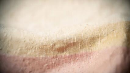 Fototapeta premium Close up view of textile showing a smooth transition from pale beige to delicate rose