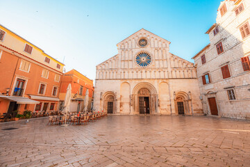Fototapeta premium Zadar, Croatia. Old town street of Zadar with the Church of St. Donatus and the bell tower of the Cathedral of St. Anastasia at sunset.