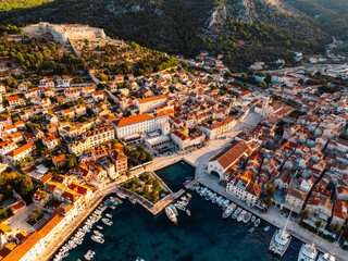 Fototapeta premium Aerial view of the historic Hvar town and the Spanish Fortress (Fortica) overlooking the harbor and Adriatic sea, Hvar island, Dalmatia, Croatia.