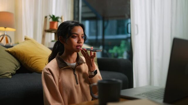 Businesswoman Using Speech to Text on Smartphone While Working From Home
