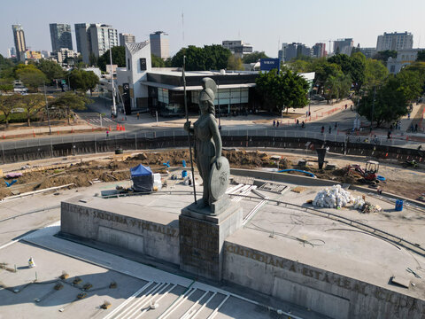 Guadalajara, Mexico - November 23 2025: Aerial view of La Minerva goddess statue in Guadalajara. Monument surrounded by urban development and construction on a sunny day