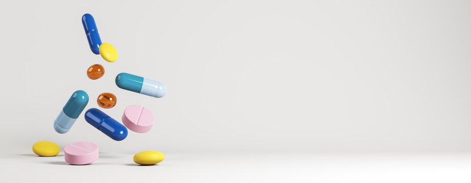 Colorful assorted medicine capsules and tablets floating in midair against a clean light background as a modern pharmacy abstract banner design. 3D Rendering