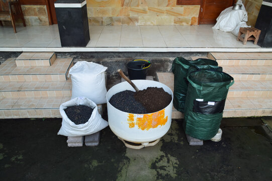 Extreme high centered composition showing soil blend ingredients and gardening tools arranged for preparing planting media for vegetable seedlings outdoors.