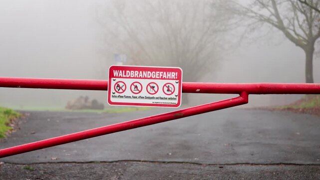 03 October 2025 Germany Munich. Warning Barrier Alerts Individuals About Imminent Wildfire Hazard Expected Ahead. Cautionary Barrier Informs People Of Impending Wildfire Danger In Vicinity