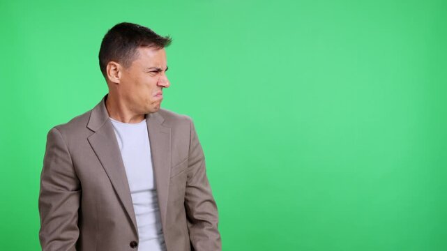 Puzzled businessman looking confused on green screen