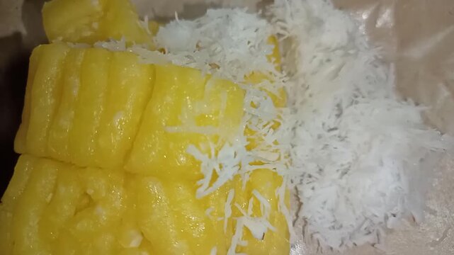 Traditional Indonesian colorful getuk lindri cassava cake served with grated coconut