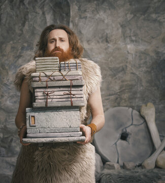 Stressed Stone Age employee carrying many files