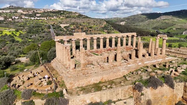 Elevated aerial view over Doric temple columns and stone ruins at the Valley of the Temples in Agrigento, Sicily, Italy.