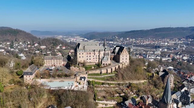 Aerial view of Landgrafen Palace, church tower, rooftops, and historic center of Marburg in Hesse, Germany.