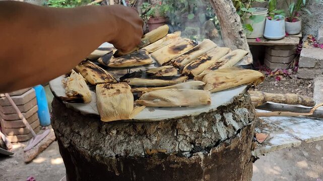 Roasting Mexican Tamales On Rustic Clay Comal Griddle Close Up