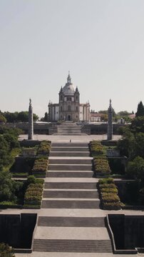 Vertical aerial drone flying towards the Sanctuary of Our Lady of Sameiro in Braga, Portugal.