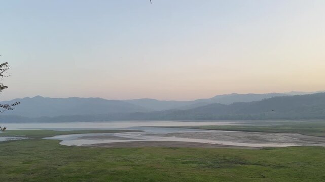 Panoramic view of jim corbett tiger reserve with river and hills in the early morning.