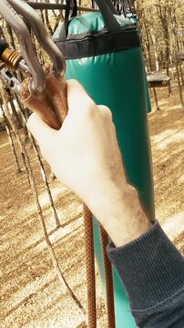 Person POV avoiding obstacles on trees in adventure park course