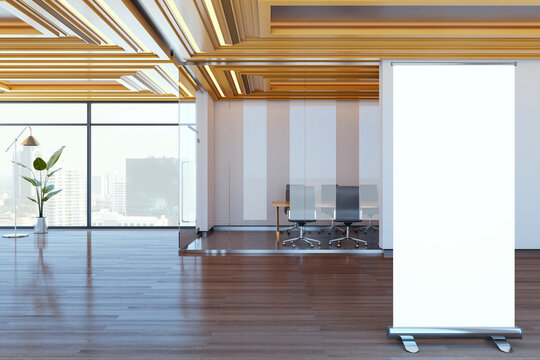 Blank rollup banner mockup standing in modern corporate office corridor with glass meeting room and wooden floor under bright contemporary light. 3D Rendering