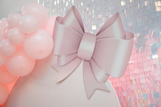 A photo zone for girls, pink or peach color. Balloons. Birthday party decoration