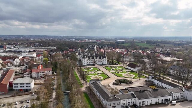 Drone view of the formal baroque garden leading to Schloss Neuhaus water castle in Paderborn, North Rhine-Westphalia, Germany.