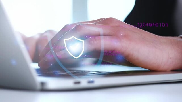 Protecting data with cybersecurity tools while using a laptop in a well-lit room during daytime.