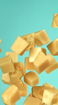 Pieces of maasdam cheese fly upwards on a blue background. Filmed on a high-speed camera at 1000 fps. High quality FullHD footage