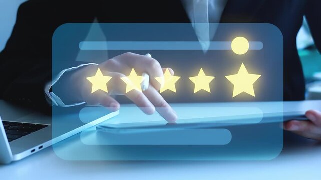 User rates service with five stars using touchscreen device while seated at desk in modern office setting during daytime.
