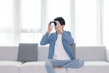 Fototapeta premium Man Using Virtual Reality Headset in Bright Living Room
