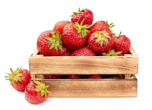 Ripe strawberries in a wooden box on a white background. Isolated