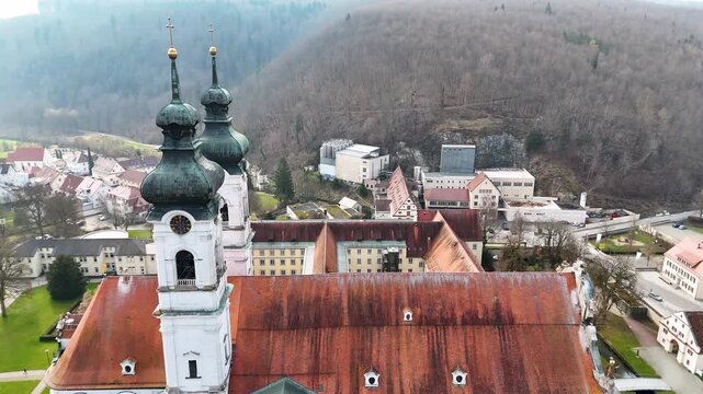 Close aerial view of the onion domes, clock faces, and crosses on Zwiefalter Munster in Zwiefalten, Baden Wurttemberg, Germany.