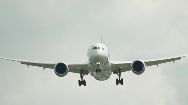 Front View of Boeing 787 Dreamliner Landing Through Cloudy Sky
