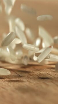 Rice falls on a wooden table. Filmed on a high-speed camera at 1000 fps. High quality FullHD footage