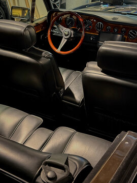 A view of the interior of a Bentley car, featuring the steering wheel and dashboard details.