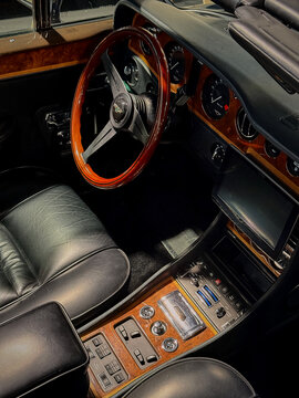 A view of the interior of a Bentley car, featuring the steering wheel and dashboard details.