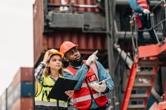 Industrial inspection cargo container safety helmet worker clipboard port logistics teamwork site communication