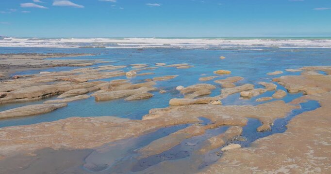4K video; Surf on a tidal plain at the Atlantic coast of Patagonia, Monte Leon National Park Argentina