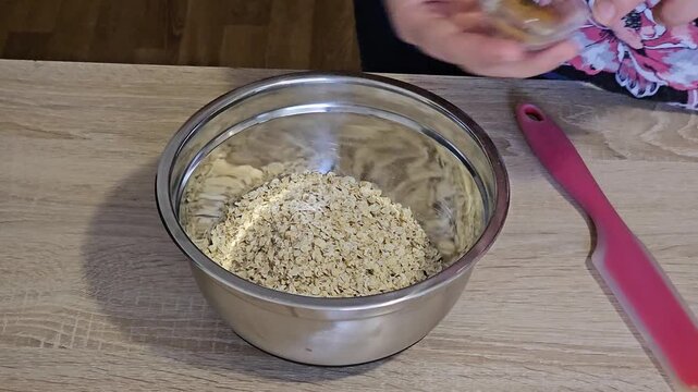 Woman preparing healthy oatmeal breakfast cereal with banana