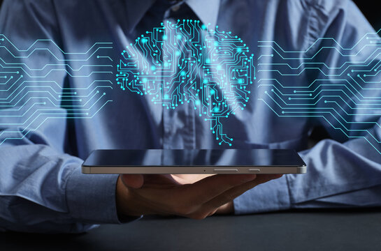 Person holding tablet showing artificial intelligence brain concept