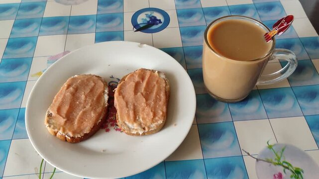 Two caviar sandwiches on plate with mug of coffee on table