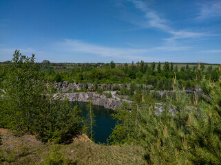 Fototapeta premium Landscape View of Water Quarry and Blue Sky