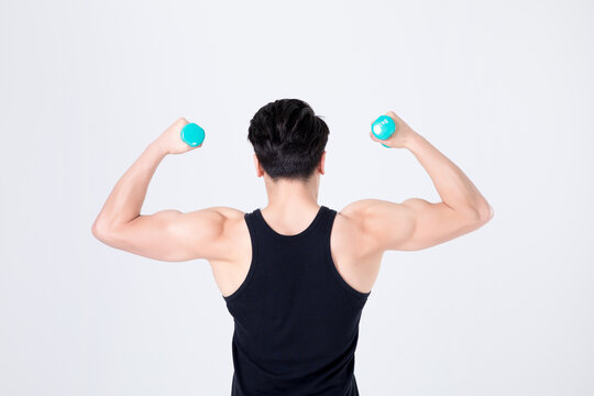 Muscular man flexing with dumbbells in fitness workout