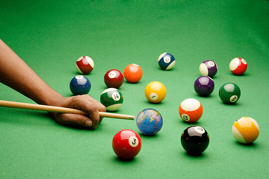 billiard table with balls and cue
