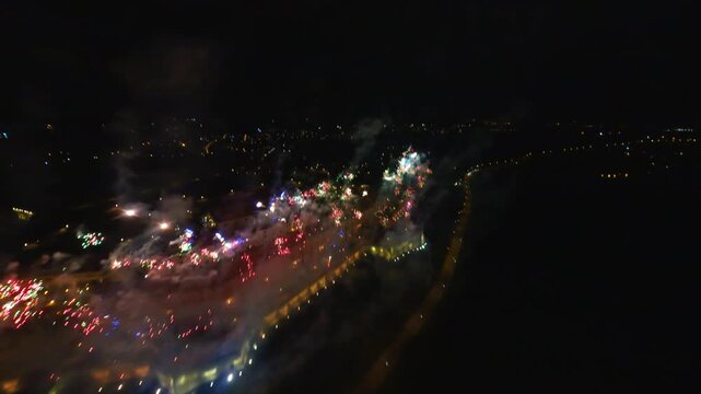 FPV aerial view of the vibrant city lights and urban landscape at night in Novi Sad, Vojvodina, Serbia.