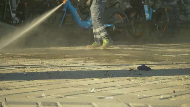Street cleaning hydrant washing pavement in Genoa, Italy