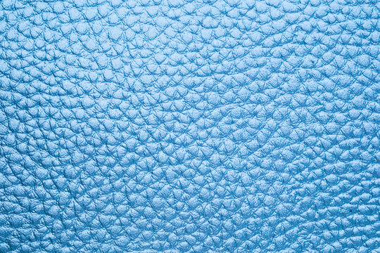 close up texture of light blue leather surface with distinct scales for backgrounds
