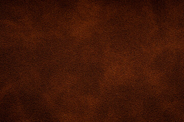 Fototapeta premium Closeup of rich brown suede texture for background use Close up of a brown suede material surface with subtle variations in tone