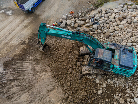 Kobelco Excavator and Workers in Rock and Sand Quarry, Mining Site from Above on May 25, 2026 in Purwokerto, Central Java, Indonesia 