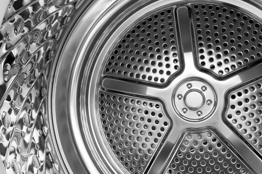 Reflective perforated metal surface inside a contemporary washing machine drum
