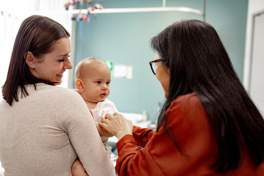 Medical practitioner interacting with mother and baby at hospital
