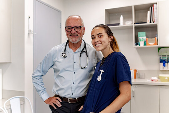 Two medical workers standing close and posing for the camera