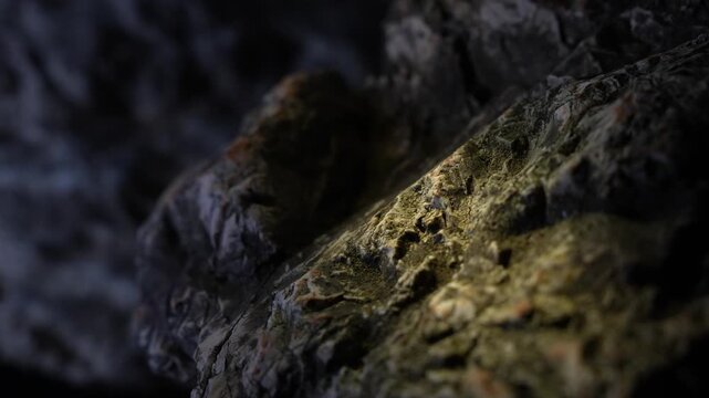 Light traveling across layered rock surface with cinematic mountain feel
