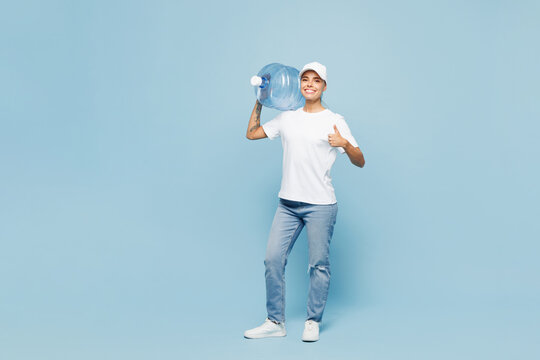 Full body delivery employee woman wear white cap T-shirt uniform workwear work as dealer courier hold in hand water cooler bottle isolated on plain pastel light blue background studio Service concept